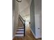Hallway featuring hardwood floors, stairs, decorative wall, and views of the living room at 1960 Calvin Dr, Duluth, GA 30097