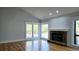 Spacious living room with stone fireplace, hardwood floors, and natural light at 1960 Calvin Dr, Duluth, GA 30097