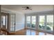 Inviting living room featuring hardwood flooring and three large windows with backyard view at 1960 Calvin Dr, Duluth, GA 30097