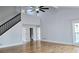 Spacious living room with high ceilings, hardwood floors, and a modern ceiling fan at 1960 Calvin Dr, Duluth, GA 30097