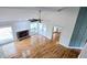 Open-concept living area with stone fireplace, wood floors, vaulted ceilings, and access to the balcony at 1960 Calvin Dr, Duluth, GA 30097