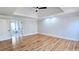 Spacious main bedroom with tray ceilings, hardwood floors, and ensuite bathroom at 1960 Calvin Dr, Duluth, GA 30097