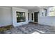 Covered outdoor patio featuring tile flooring, large windows, and glass doors at 1960 Calvin Dr, Duluth, GA 30097
