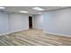 Spacious room with wood flooring, white walls, base molding, and recessed ceiling lights at 1960 Calvin Dr, Duluth, GA 30097