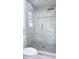 Contemporary shower featuring marble and glass enclosure with geometric accent tile at 1960 Calvin Dr, Duluth, GA 30097