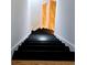 Modern staircase featuring black painted steps with light wood flooring at 1960 Calvin Dr, Duluth, GA 30097