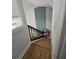 Staircase featuring hardwood floors and black wood banister leads to the second floor at 1960 Calvin Dr, Duluth, GA 30097