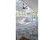 Bright sunroom with multiple windows, a ceiling fan, skylights, and tile flooring at 1960 Calvin Dr, Duluth, GA 30097