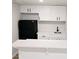 Basement wet bar area featuring white cabinetry, a black mini fridge and white countertops at 1960 Calvin Dr, Duluth, GA 30097
