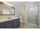 Modern bathroom featuring a vanity, a walk-in shower with marble tiling and silver hardware at 7130 Spalding Ne Ct, Atlanta, GA 30328