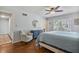 Light-filled bedroom with hardwood floors, neutral walls, and a cozy sitting area at 7130 Spalding Ne Ct, Atlanta, GA 30328