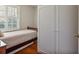 Bright bedroom with white shutters on the window and wooden floors at 7130 Spalding Ne Ct, Atlanta, GA 30328