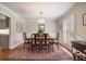 Elegant dining room featuring a wooden table, patterned rug, and bright window at 7130 Spalding Ne Ct, Atlanta, GA 30328