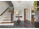 Welcoming foyer with slate floors, wooden stairs, and decorative wreath on the front door at 7130 Spalding Ne Ct, Atlanta, GA 30328