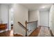 Hallway with hardwood floors, staircase, and neutral walls leading to various rooms at 7130 Spalding Ne Ct, Atlanta, GA 30328