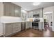 Well-lit kitchen with stainless steel appliances, grey cabinetry, and hardwood floors at 7130 Spalding Ne Ct, Atlanta, GA 30328