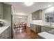 Modern kitchen with stainless steel appliances, gray cabinets, and a dining area at 7130 Spalding Ne Ct, Atlanta, GA 30328
