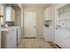 Functional laundry room with washer, dryer, cabinets, utility sink and access to exterior door at 7130 Spalding Ne Ct, Atlanta, GA 30328