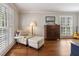 Cozy living room with plantation shutters, hardwood floors, and comfortable seating at 7130 Spalding Ne Ct, Atlanta, GA 30328