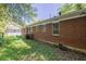 Side yard view of the exterior of the brick home at 1239 Avonwood Sw Cir, Atlanta, GA 30311