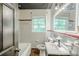 Bathroom with a vintage sink, tiled walls and floors, and a tub and shower combo at 1239 Avonwood Sw Cir, Atlanta, GA 30311