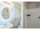 A bathroom with a round mirror, a walk-in shower and lots of light at 1239 Avonwood Sw Cir, Atlanta, GA 30311
