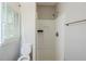 A bathroom featuring a walk-in shower, toilet and small window at 1239 Avonwood Sw Cir, Atlanta, GA 30311