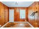 Bedroom featuring wooden walls, hardwood floors, two windows and modern lighting at 1239 Avonwood Sw Cir, Atlanta, GA 30311