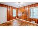 Bedroom featuring wooden walls, hardwood floors, and 2 windows at 1239 Avonwood Sw Cir, Atlanta, GA 30311