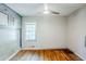 A bedroom featuring hardwood floors, a ceiling fan, and a bright window at 1239 Avonwood Sw Cir, Atlanta, GA 30311