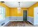 Bright dining room with a stylish light fixture, hard wood floors, and natural light at 1239 Avonwood Sw Cir, Atlanta, GA 30311