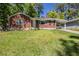 Charming brick home featuring a carport, well-maintained lawn, and mature trees at 1239 Avonwood Sw Cir, Atlanta, GA 30311