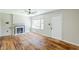 Cozy living room featuring hardwood floors, a fireplace, and abundant natural light at 1239 Avonwood Sw Cir, Atlanta, GA 30311