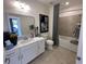 Bathroom featuring a modern vanity, large mirror, and shower-tub combo at 1702 Bonica Xing # 1702, Cumming, GA 30040