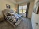 Bright bedroom featuring neutral decor, a large window, and soft carpeting at 1702 Bonica Xing # 1702, Cumming, GA 30040