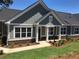 Charming single-story home with gray siding, white trim, and a well-manicured lawn and landscape at 1702 Bonica Xing # 1702, Cumming, GA 30040