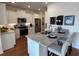 Modern kitchen featuring stainless steel appliances, granite countertops, and breakfast bar seating at 1702 Bonica Xing # 1702, Cumming, GA 30040