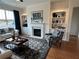 Bright living room featuring a fireplace, built-in shelving, and hardwood flooring at 1702 Bonica Xing # 1702, Cumming, GA 30040