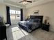 Comfortable main bedroom with tray ceiling, a large window, and neutral decor at 1702 Bonica Xing # 1702, Cumming, GA 30040