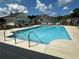 Inviting community pool surrounded by lounge chairs and well-maintained landscaping at 1702 Bonica Xing # 1702, Cumming, GA 30040