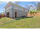 Spacious backyard with green grass and a grey sided home at 1903 River Birch Ln, Atlanta, GA 30316