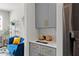 Stylish dry bar adjacent to the kitchen featuring grey cabinets and gold hardware at 1903 River Birch Ln, Atlanta, GA 30316