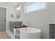 Bright bathroom featuring stylish soaking tub with tub filler, double sinks, and neutral color palette at 1903 River Birch Ln, Atlanta, GA 30316