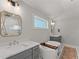 Bright bathroom with vanity, soaking tub and decorative rug at 1903 River Birch Ln, Atlanta, GA 30316