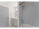 Modern bathroom featuring gray vanity, tub, and shower with stylish tile at 1903 River Birch Ln, Atlanta, GA 30316