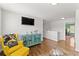 Bonus Room featuring hardwood floors, TV, yellow chair and doorway to another room at 1903 River Birch Ln, Atlanta, GA 30316