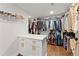 Walk-in closet with custom shelving, wooden floors and central island provides an abundance of storage space at 1903 River Birch Ln, Atlanta, GA 30316
