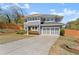 Well-maintained home featuring gray siding, a spacious driveway, and a neatly landscaped front yard at 1903 River Birch Ln, Atlanta, GA 30316