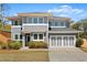Beautiful home with a well-manicured lawn, gray siding, white trim, and an attached two-car garage at 1903 River Birch Ln, Atlanta, GA 30316