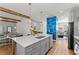 Open-concept kitchen with a center island, gray cabinets, stainless steel appliances, and stylish lighting at 1903 River Birch Ln, Atlanta, GA 30316